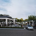 Modern Urban Commercial Street Landscape Design With Outdoor Umbrellas Pedestrians And Greenery