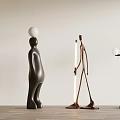 Abstract Metal Sculptures With Balancing Balls And Standing Figures In Modern Interior