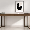 Brown Wooden Desk With Stack of Books and Framed Monochrome Abstract Artwork Against White Wall