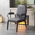 Gray Accent Chair With Wooden Frame And Armrests In Living Room Featuring Fireplace Flames
