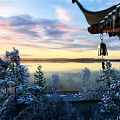 Snow Covered Pagoda And Trees By Lake Under Sunset Sky With Hanging Bell