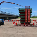 Construction Site Featuring Tower Crane Concrete Mixer Safety Barriers And High Rise Building