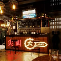 Stylish Bar Interior Featuring Neon Sign Bar Counter Hanging Lights And Wine Racks
