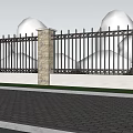 Building Exterior Wall With Black Iron Fence Stone Pillar Green Trees And Red Flower Bushes