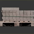 Stacked Gray Bricks on Wooden Pallet with Green Straps and Orange Label