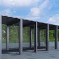 Modern Pergola with Metal Frame and Vertical Pillars Surrounded by Green Trees and Open Landscape