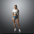 Woman In White Cropped Top And Denim Shorts With White Sneakers On Gray Background