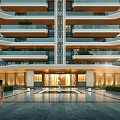 Modern High Rise Building Main Entrance with Illuminated Facade Glass Doors and Landscaped Water Feature