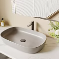 Gray Washbasin on Marble Countertop with Mirror Soap Dispensers and White Flowers in Bathroom Interior