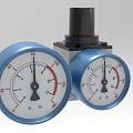 Industrial Equipment Featuring Dual Blue Pressure Gauges And Central Black Component