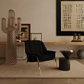 Black Upholstered Leisure Chair With Gold Legs Near Side Table Glass Cactus And Wall Art