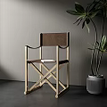 Wooden Frame Leisure Chair With Brown Cushion And Green Plant In Gray Pot