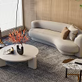 Modern Beige Curved Sofa And Round Marble Coffee Table Set With Decorative Vase On Rug