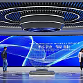 Tech Inspired Exhibition Hall Interior Featuring Blue Large Screen Curved Ceiling and Circular Floor Lines