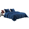Modern Double Bed With Blue Duvet White Pillows And Wooden Headboard