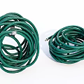 Green Garden Hoses Coiled In Two Rolls For Outdoor Watering Applications