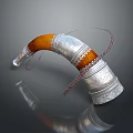 Horn Shaped Silver Carved Sculpture With Orange Accent And Braided Details