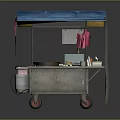 Mobile Food Cart with Blue Canopy Featuring Cooking Utensils Condiment Bottles Hanging Cloths and Wheels