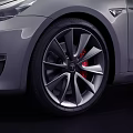 Silver Tesla Sedan With Sleek Modern Exterior And Black Alloy Wheels