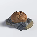 Artisanal Rustic Bread with Crusty Exterior on Checkered Cloth and Wooden Board