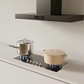 Modern Kitchen With Black Range Hood Gas Stove And Metal Beige Pots
