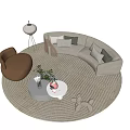 Curved Gray Sofa with Pillows and Two Coffee Tables on Woven Rug and Accent Chair