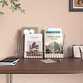 Books And Magazines Organized In Wire Rack On Wooden Desk With Calendar Pens And Papers