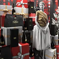 Christmas Shop Window Display Featuring Dior Shopping Bag Gift Boxes Wine Bottles Mannequin and Decorated Tree
