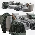 Cozy Multi Seater Sofa With Soft Gray Blankets And Beige Green Cushions