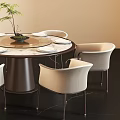 Modern Round Dining Table Set with Six White Chairs Central Green Plant and Pendant Light