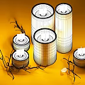 Glass Candle Lamps With Lit Candles And Twigs On Yellow Background