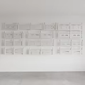 White Decorative Shelves Arranged on Wall With Various Designs and Patterns