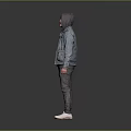 Man Wearing Hoodie And Denim Jacket With Dark Pants And White Shoes Against Gray Background