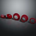 Red Circular Flanges Equipment With Various Sizes Arranged On Dark Background