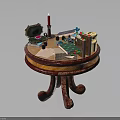 Vintage Round Wooden Table with Carved Legs and Items Like Open Box Candle Playing Cards