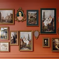 Orange Wall Decorated With Various Framed Paintings Mirrors And Ornate Decorative Items