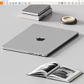 Silver Apple Laptop on Desk with Stacked Books Open Magazine and Coaster