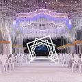 Luxurious Banquet Hall With Crystal Chandeliers White Chairs And Elegant Stage Lighting Design
