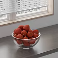 Fresh Ripe Red Lychees in Glass Bowl on Gray Countertop by Window Blinds
