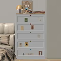 White Chest of Drawers With Colorful Knobs Decorative Tags And Lamp On Top In Bedroom