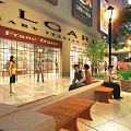 Lively Commercial Street Pedestrian Area with Storefronts Benches Street Lamps Green Plants and People Relaxing
