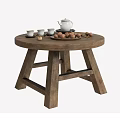 Round Wooden Coffee Table With Crossed Legs Design Featuring Tea Set Nuts And Tea Cups