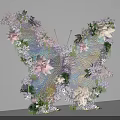 Butterfly Shaped Art Installation With Pink White Purple Flowers Green Leaves and Transparent Wings