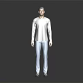 Man in Light Gray Long Sleeve Top and Light Blue Jeans Standing Against Dark Background