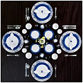 Blue And White Dinnerware Set With Plates Glasses Napkins Candles And Flowers On Dining Table