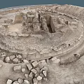 Ancient Stone Ruins With Circular Stone Walls And Scattered Blocks In Archaeological Site