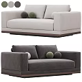 Green Velvet Two Seater Sofa With Round Pillows And Dark Wooden Base