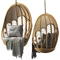 Wicker Hanging Chair With Intricate Pattern Cozy Pillows And Plaid Blanket For Home Interior