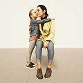 Affectionate Woman and Boy Hugging in Light Room With Carpeted Floor
