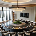 Elegant Banquet Hall Interior Featuring Round Dining Table Chandelier Green Plant Centerpiece And TV Screen